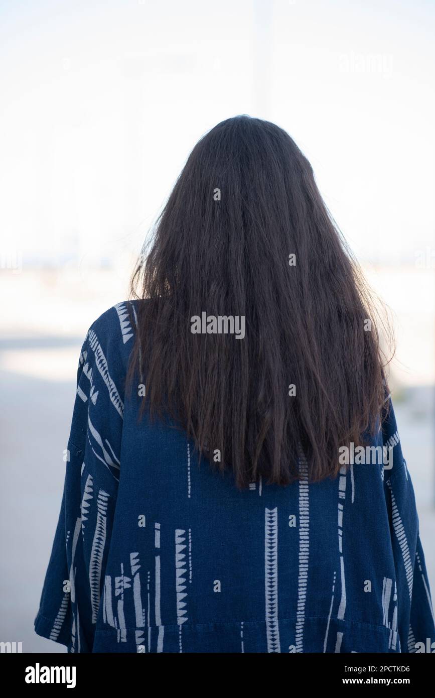 Rear view of young woman outdoors Stock Photo - Alamy