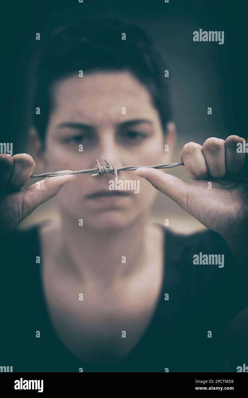 Serious woman holding barbwire stock photo alamy