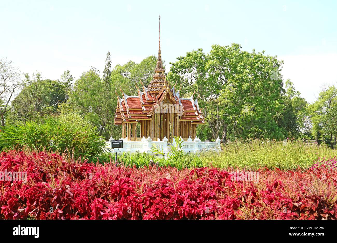 Fantastic Thai Ancient Style Pavilion with Shrubs of Red Coleus in Foreground Stock Photo