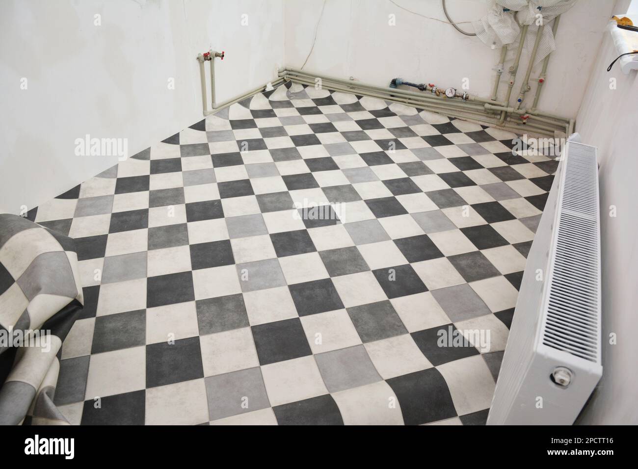Linoleum or lino laying on the floor in the kitchen with boiler heater