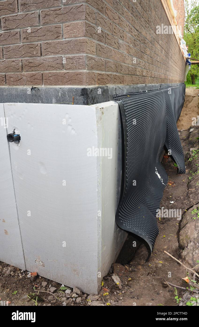 Foundation, basement waterproofing and damp proofing. Installation of dimpled waterproofing