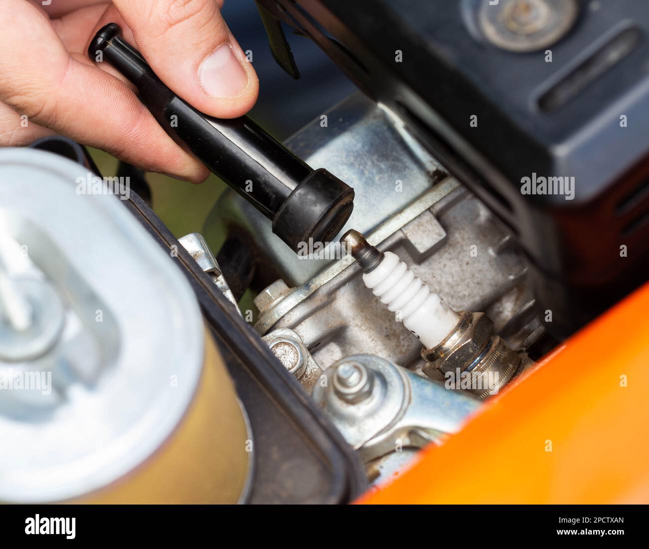 Replacing the spark plug in the motor block engine cylinder