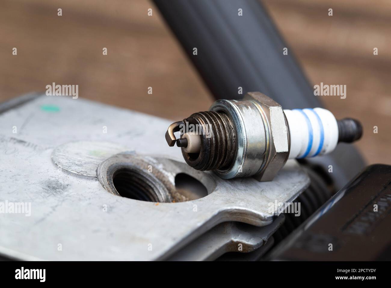 Spark plug unscrewed from the cylinder of the combustion chamber of a