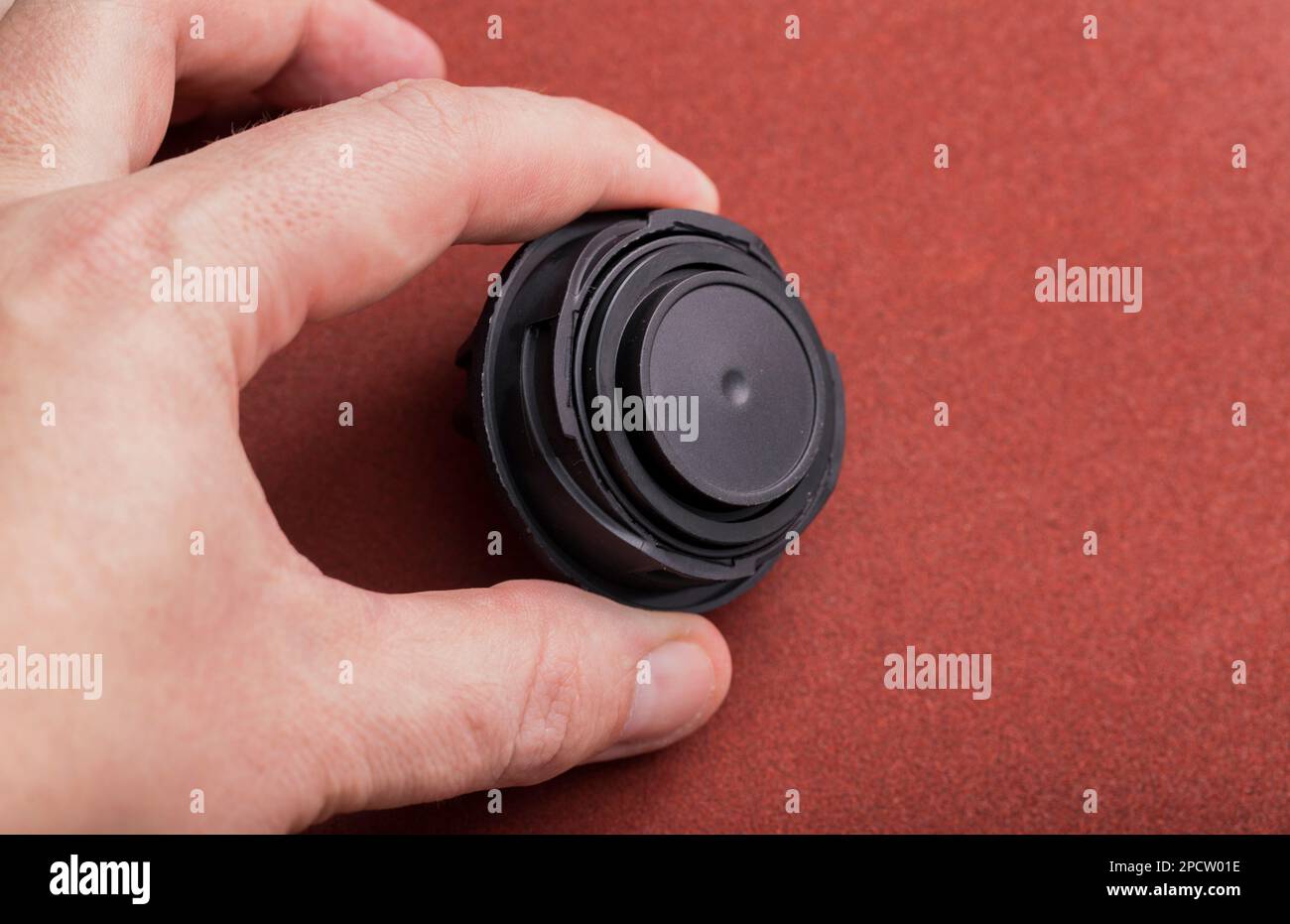 Black car oil filler cap in the mechanic's hand Stock Photo Alamy
