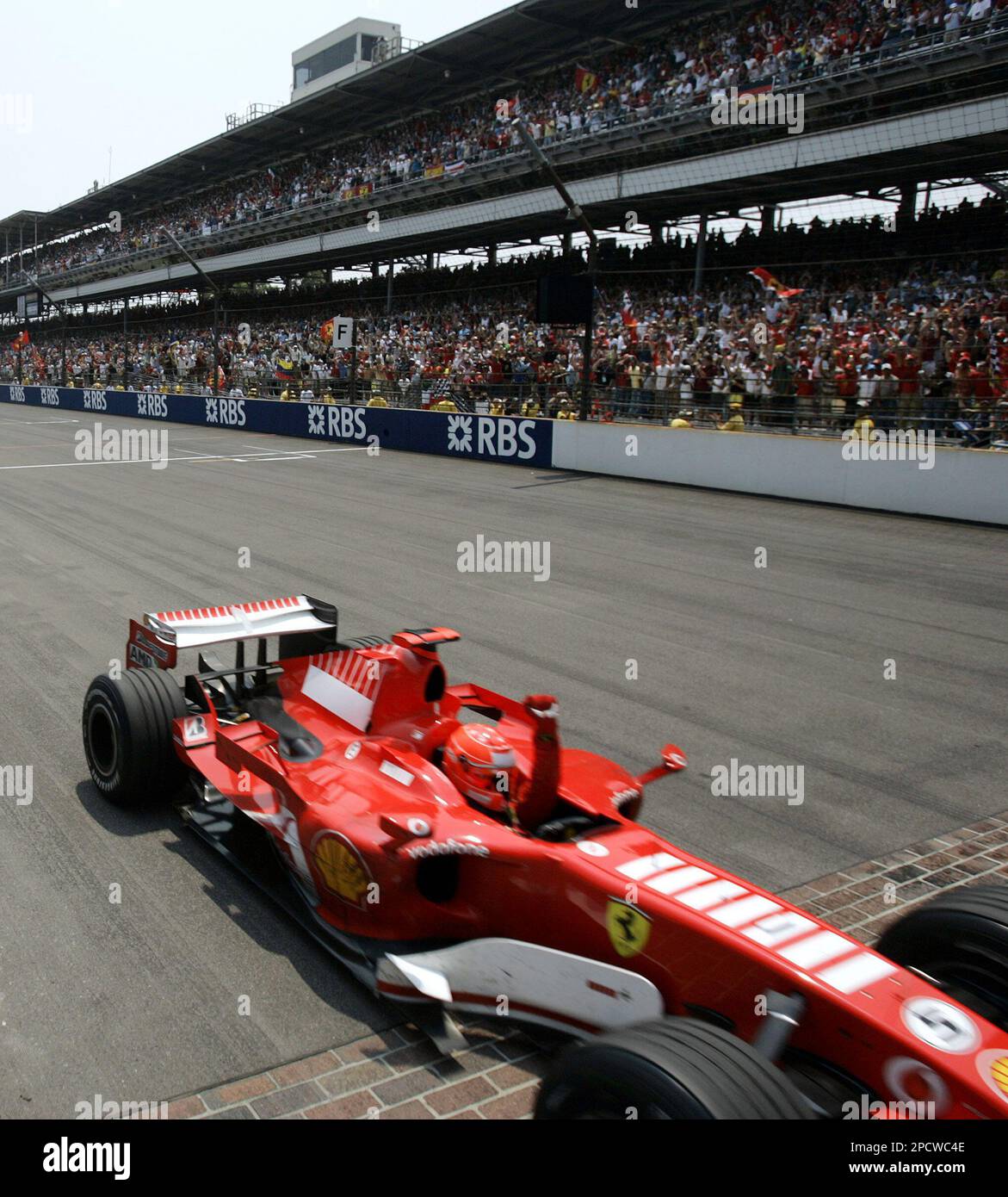 Michael Schumacher, of Germany, pumps his fist as he takes the