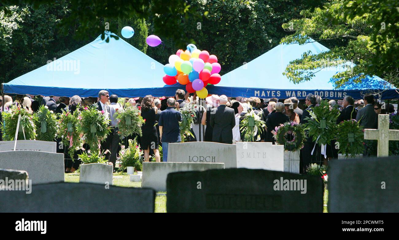 Attendees pay their respects at the graves of Patsy Ramsey, and daughter  JonBenet, during services for Patsy Ramsey at the St. James Episcopal  Cemetery in Marietta, Ga., Thursday, June 29, 2006. Ramsey