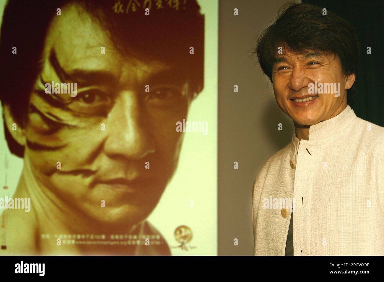 hong-kong-movie-star-jackie-chan-poses-next-to-a-poster-with-him-mocked