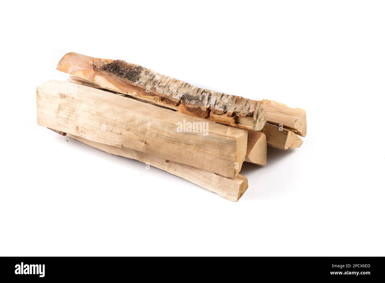 Stack of cut logs firewood from silver birch tree isolated on white