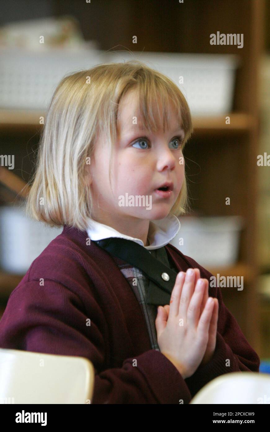 Kara Wheeler, 6, prays along with kindergarten classmates before eating  lunch on May 8, 2006, at Richland Catholic School in Richland, Mich. This  year is the tenth anniversary for the Richland Catholic