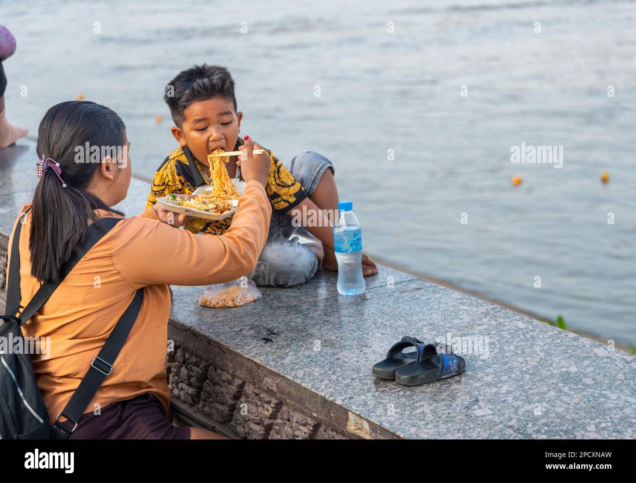 Phnom Penh,Cambodia-December 23 2023: The Riverside Promenade,is a nce place for Khmer families to to come to eat,pray and socialize,next to the Tonle Stock Photo