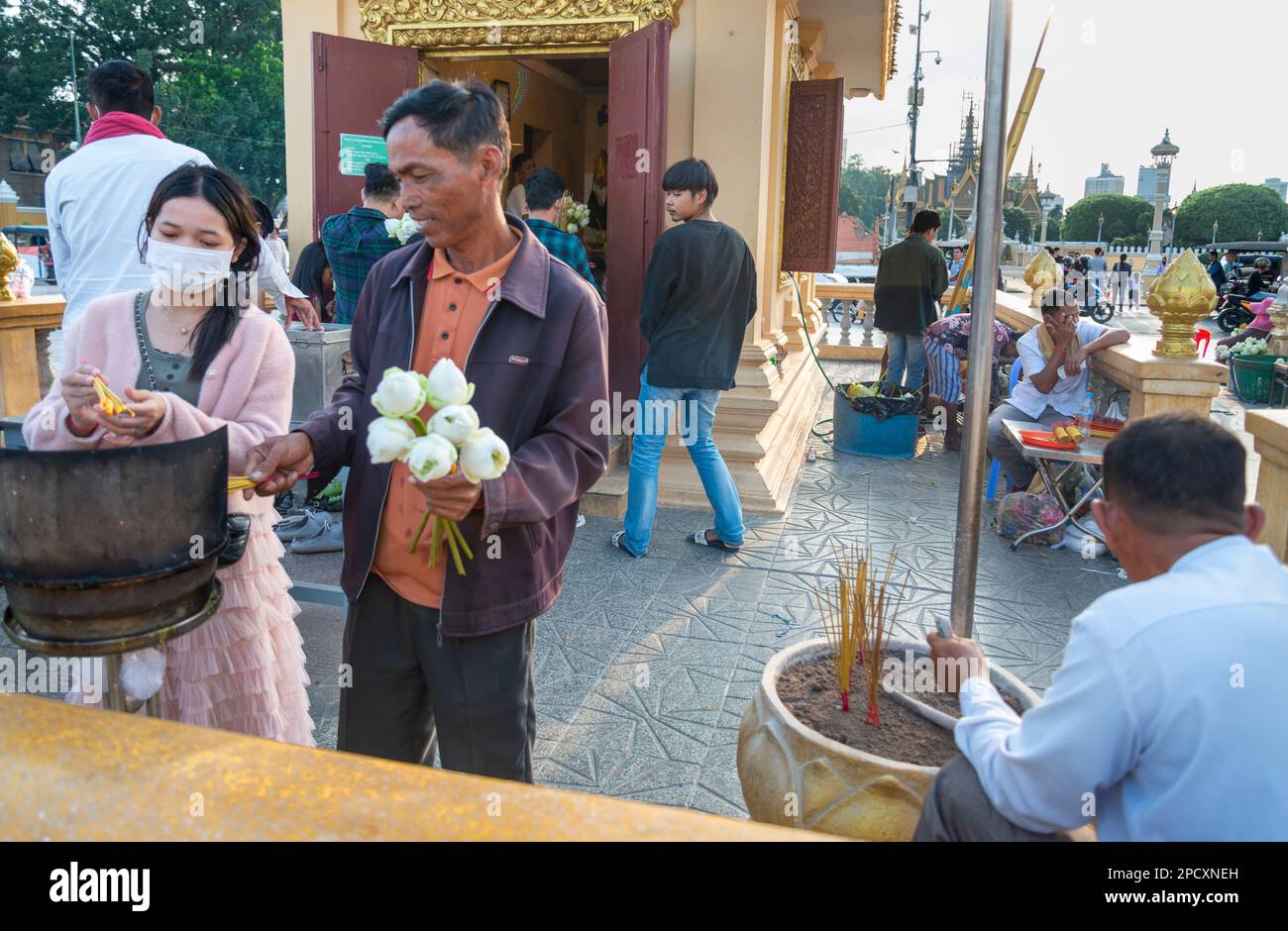 Phnom Penh,Cambodia-December 23 2023: Along the Riverside Promenade,devout Khmer men,women and families gather in the relatively cool,late afternoons Stock Photo