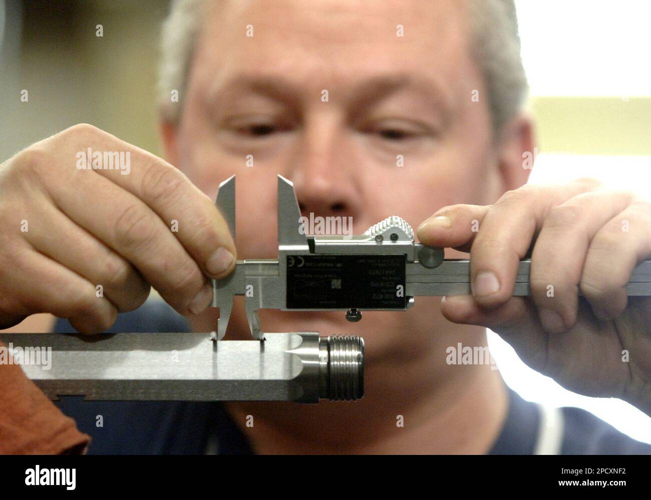 ** ADVANCE JUNE 2425 ** Craftsman Neil Wellnitz uses a chronometer to