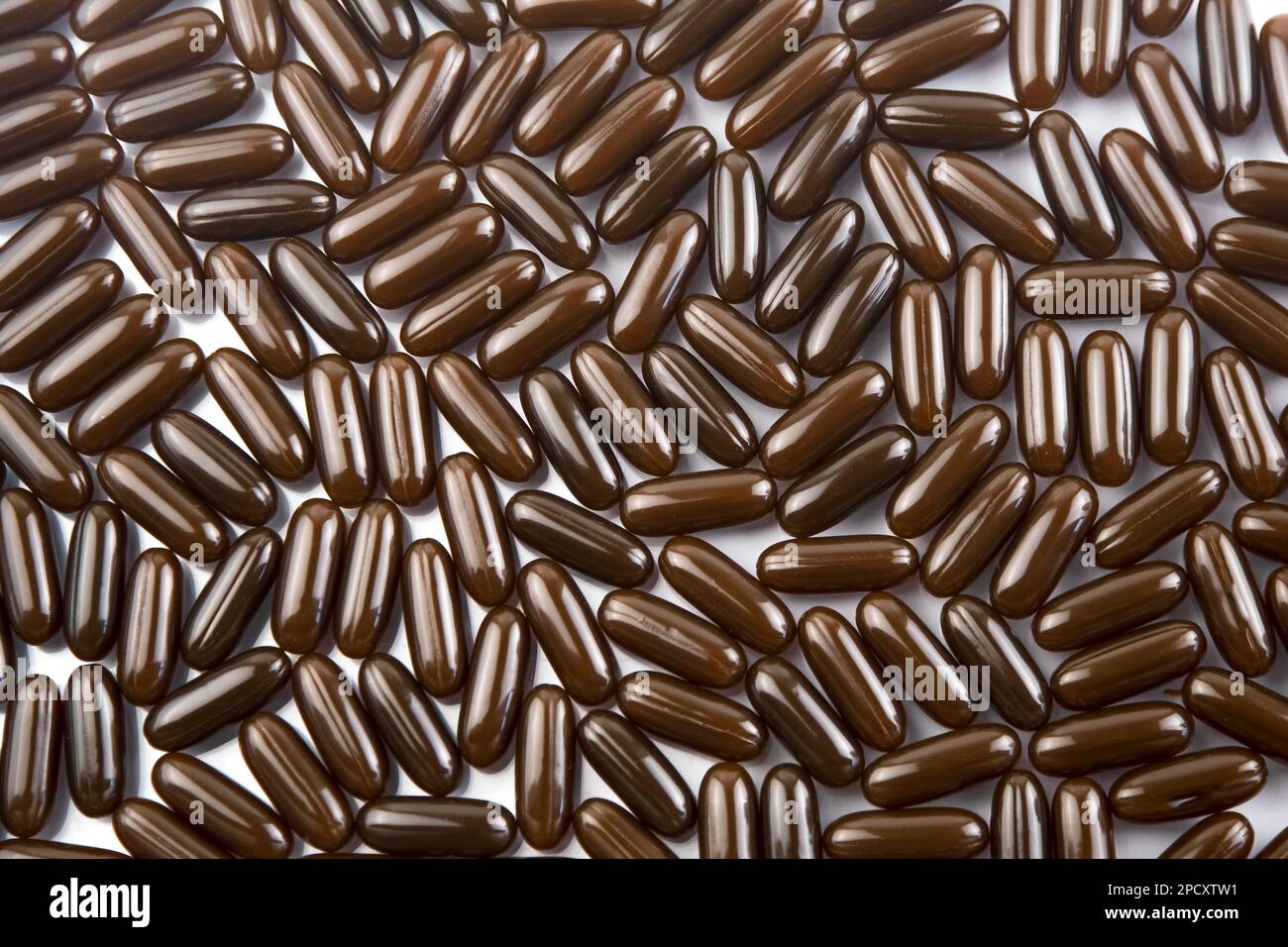 A lot of brown pills top view. Vitamins tablet background. Treatment