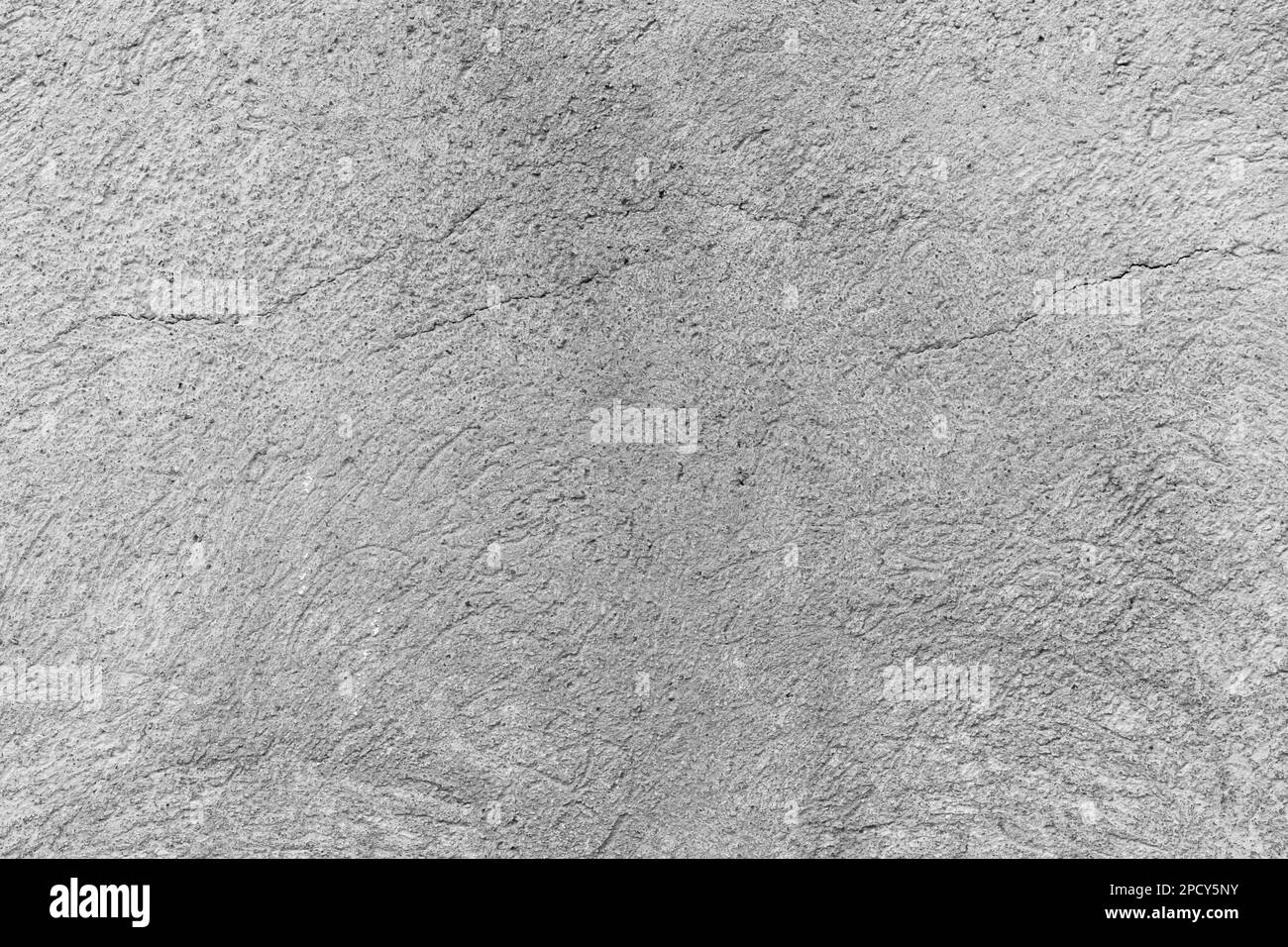 Concrete cracked rough wall background closeup Stock Photo