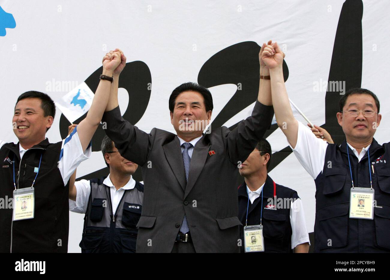 Choi Chang-man, center, head of a delegation of North Korean workers'  group, holds the hands of Korean Confederation of Trade Union President Jo  Jun-ho, left, and Federation of Korean Trade Unions President