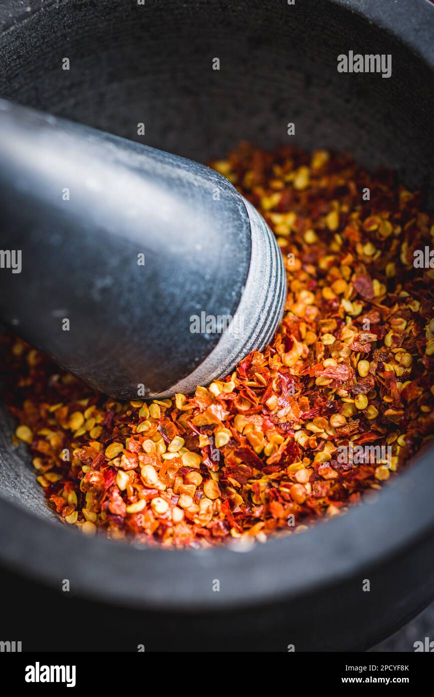 Dry chili pepper flakes. Crushed red peppers in the mortar Stock Photo Alamy