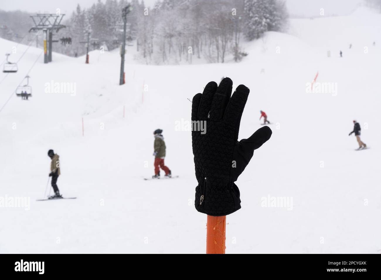 Snow glove was placed on a fence in ski resort in Japan Stock Photo