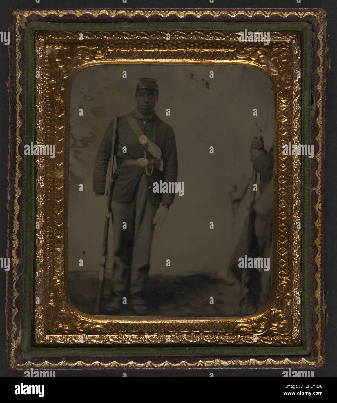 Unidentified African American soldier in Union uniform and gloves with ...