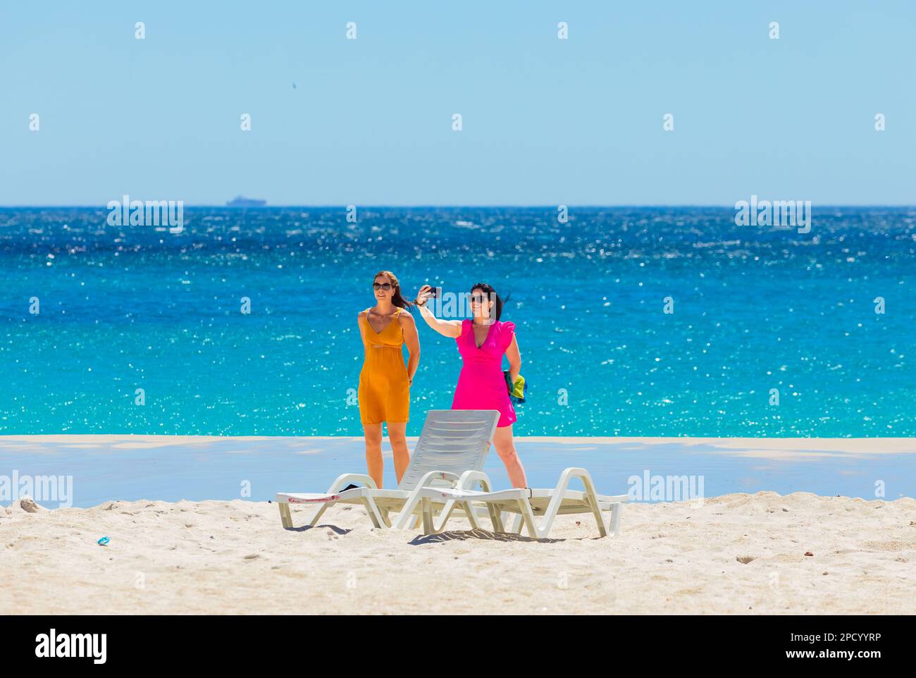 Cape Town, South Africa - February 18, 2023: Young female vacationers on Camps Bay beach Stock Photo
