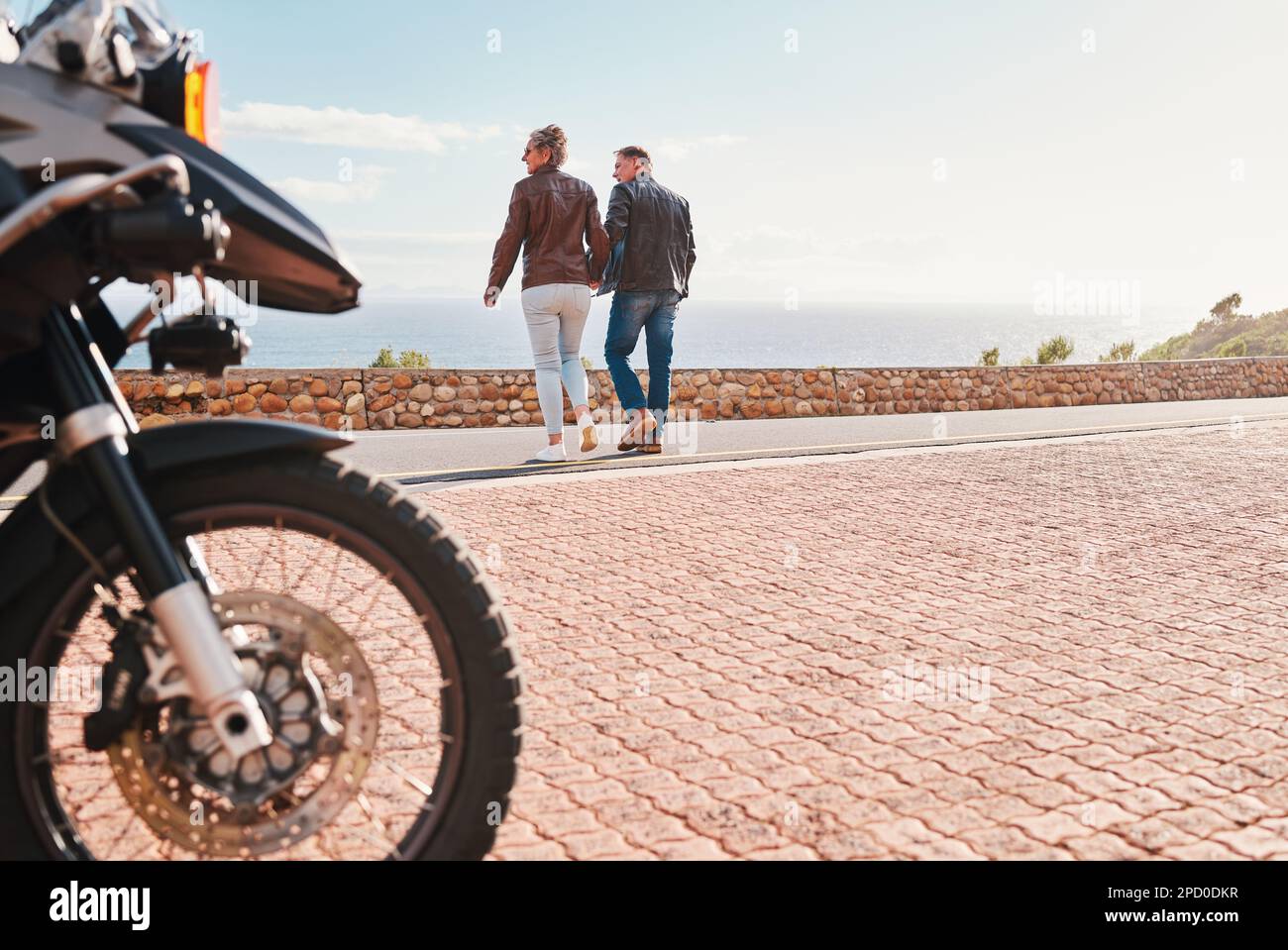 Back, view and a biker couple on a road trip together in summer during retirement. Motorcycle, freedom or travel with a senior man and woman traveling Stock Photo