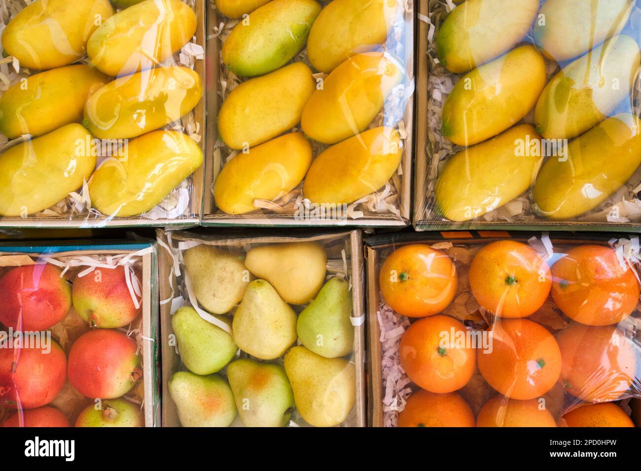Sample of a gift bruit box, made of fake, plastic oranges, mangoes. At