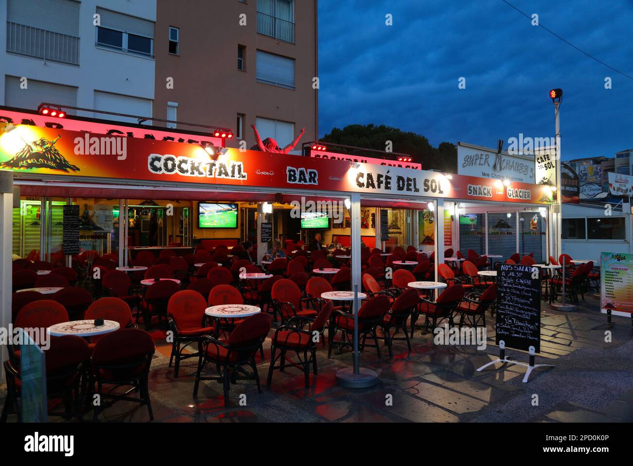 CAP D'AGDE, FRANCE - OCTOBER 2, 2021: Evening cafe and cocktail bar street view of Cap d'Agde resort in Occitanie region of France. Stock Photo