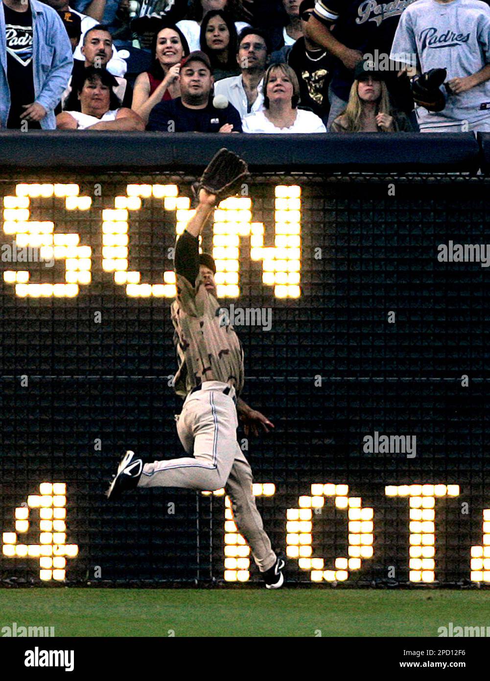 San Diego Padres left fielder Dave Roberts takes an extra base hit away  from Colorado Rockies' Clint Barmes in the sixth inning of their baseball  game Monday, May 29, 2006, in San