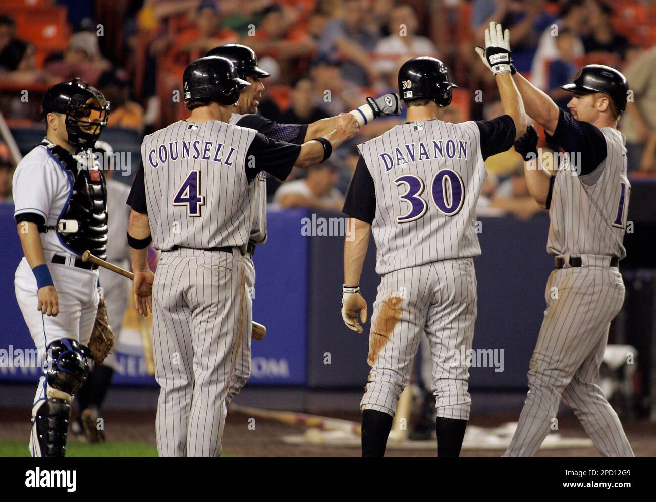 New York Mets catcher Paul Lo Duca watches as Arizona Diamondbacks Chad  Tracy is congratulated by Jeff DaVanon, Craig Counsell and Luis Gonzalez  after hitting a three run home run during the