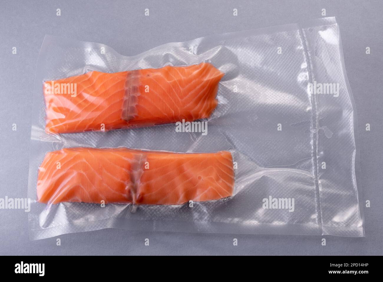 Salmon slices in vacuum packed sealed for sous vide cooking on Gray