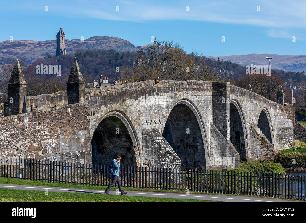 Stirling Old Bridge over the River Forth, with the Wallace Monument visible in the background, in the city of Stirling in Scotland Stock Photo