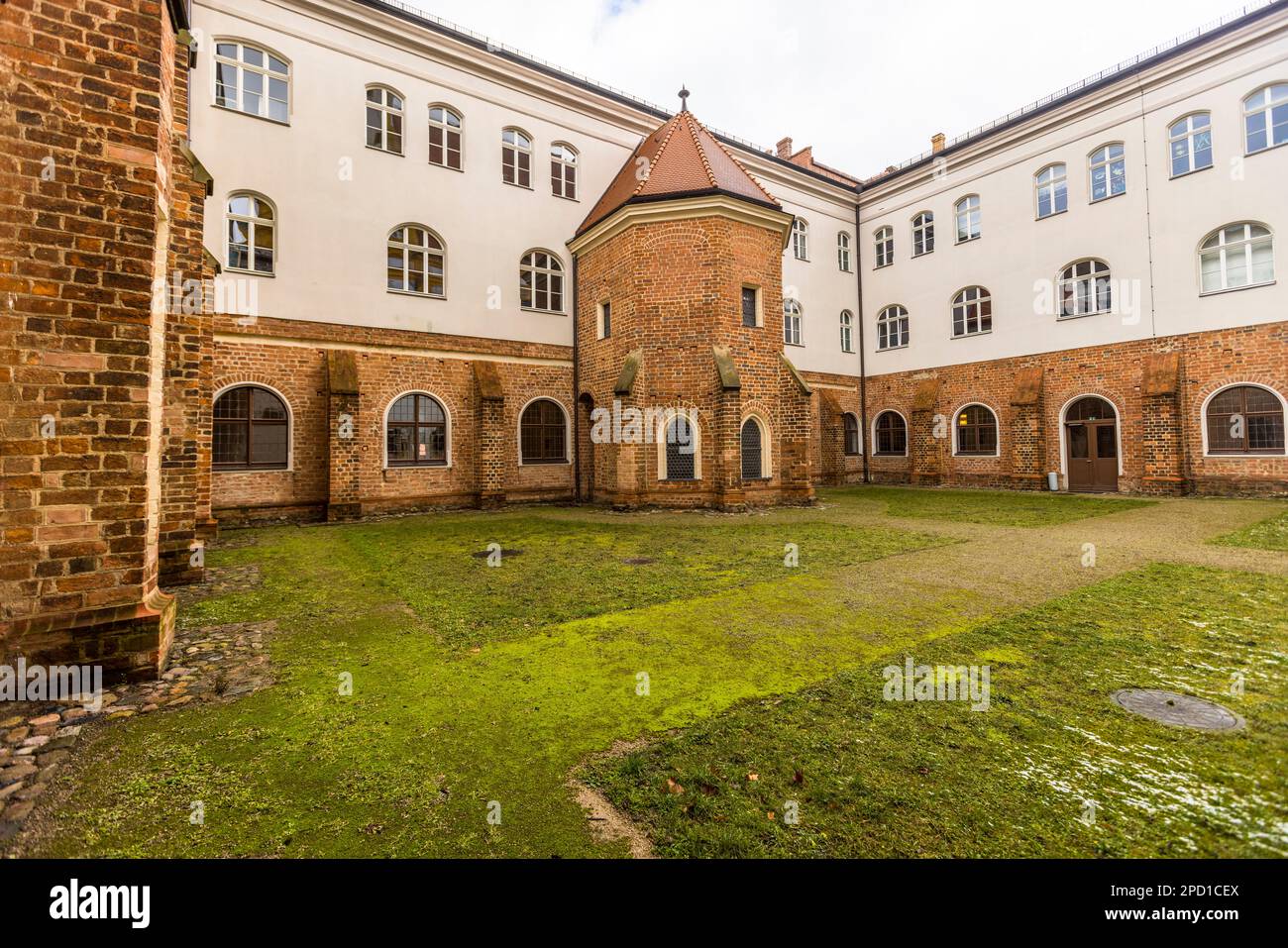 Neuzelle Baroque Monastery, Germany. Inner courtyard of the Neuzelle monastery complex. The brick of the cloister indicates its Gothic origin. The monastery was founded in 1268 by market count Heinrich von Meißen Stock Photo