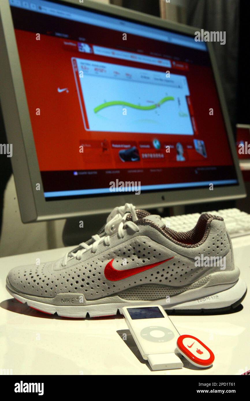 The Nike Air Zoom Moire is photographed alongside an iPod and the Nike+iPod Sport  Kit and a computer screen displaying the nikeplus.com website, Tuesday May  23, 2006 in New York. Nike and