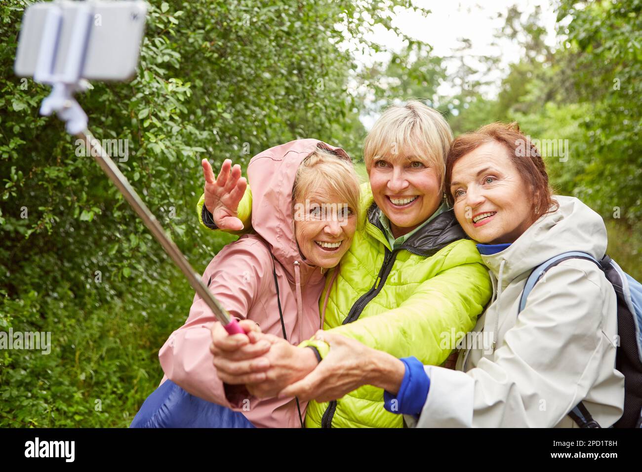 Happy senior woman taking selfie with smartphone on hiking trip in ...