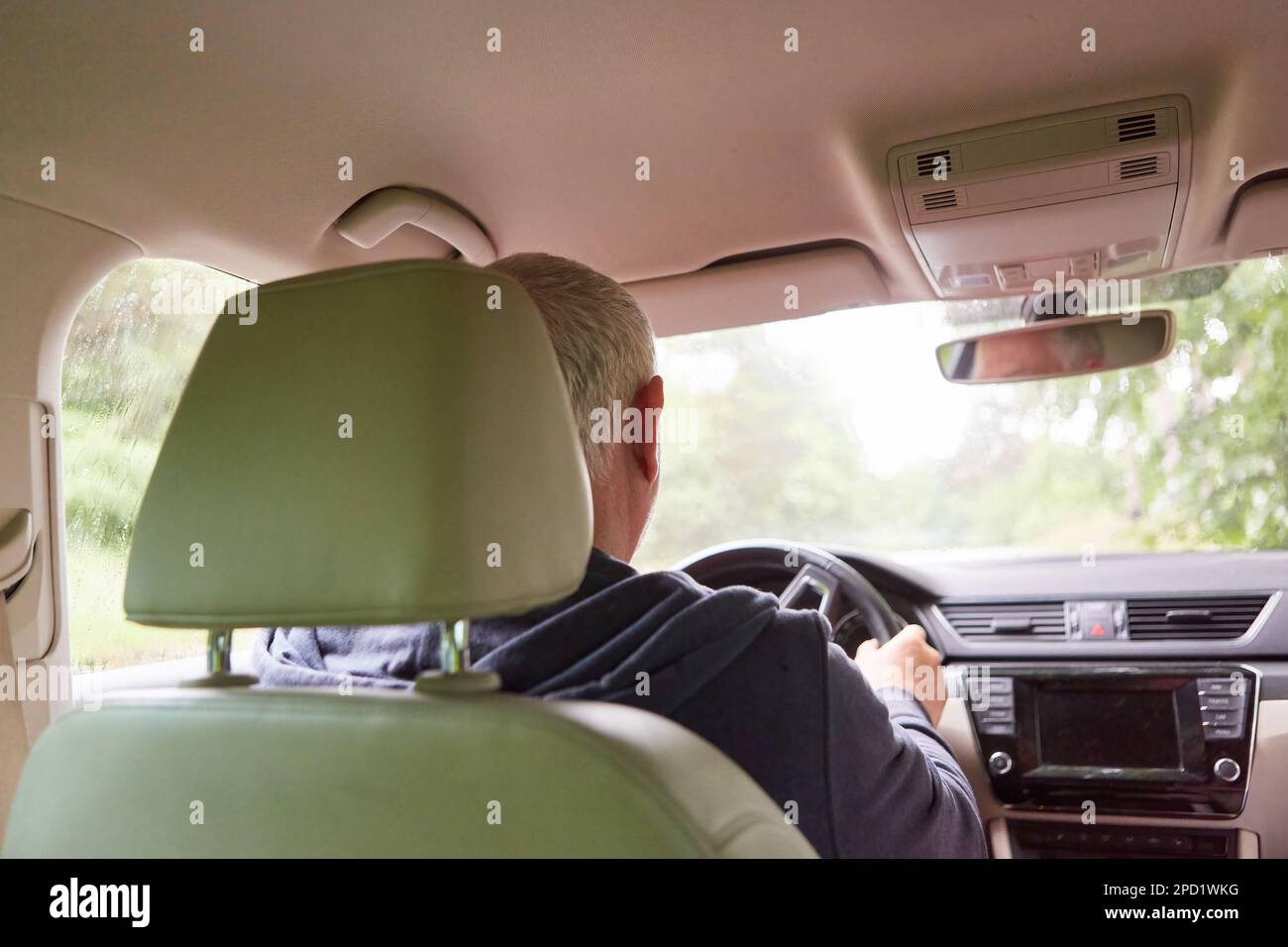 Senior man driving car during road trip at vacation Stock Photo