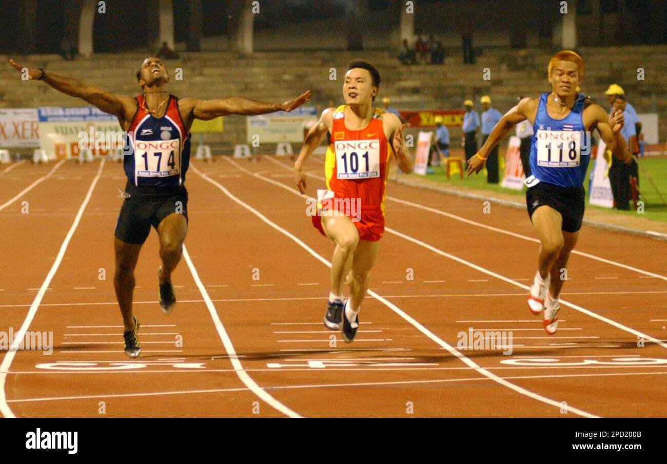 China's Yongyi Wen, center, wins the men's 100 meters at the Asian
