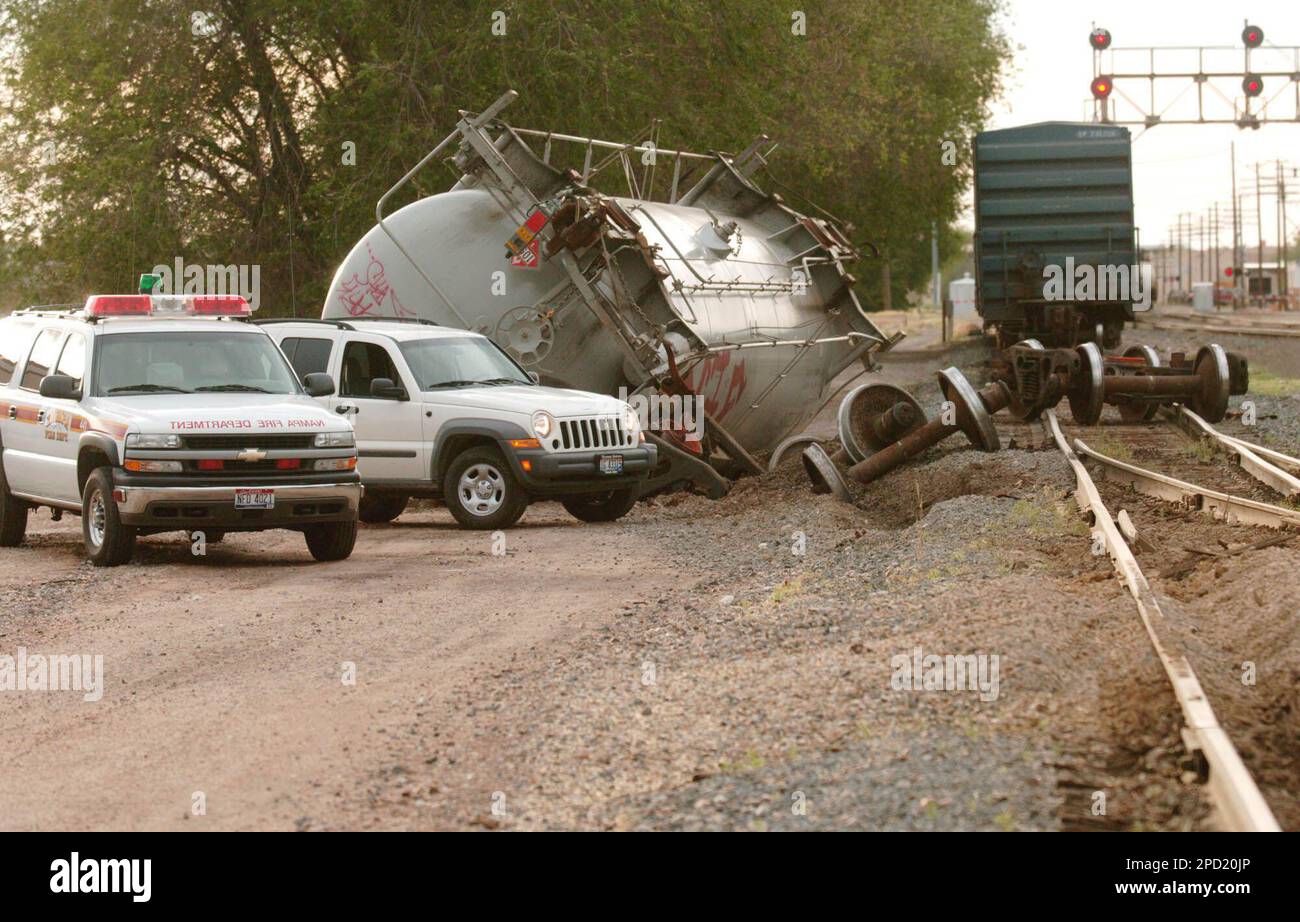 A derailed tank car carrying 28 000 gallons of acetone lays on its