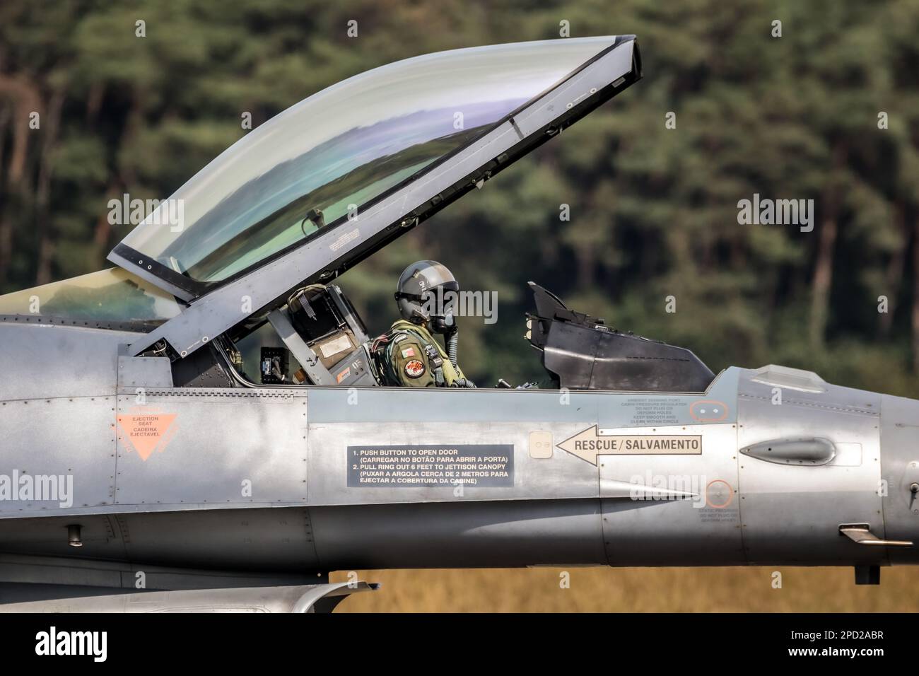 Portuguese military pilot with it's helmet on in the cockpit of a F-16 fighter jet at Kleine Brogel Airbase. Belgium - September 13, 2021 Stock Photo
