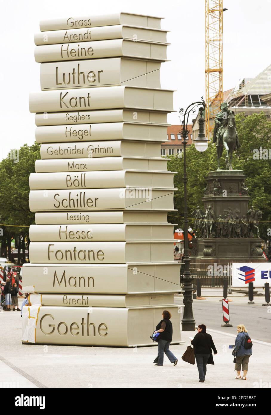 Visitors look at a sculpture erected by the initiative "Germany - Land of  Ideas", depicting piled up books by German writers, in Berlin on Friday,  May 19, 2006. The initiative set up