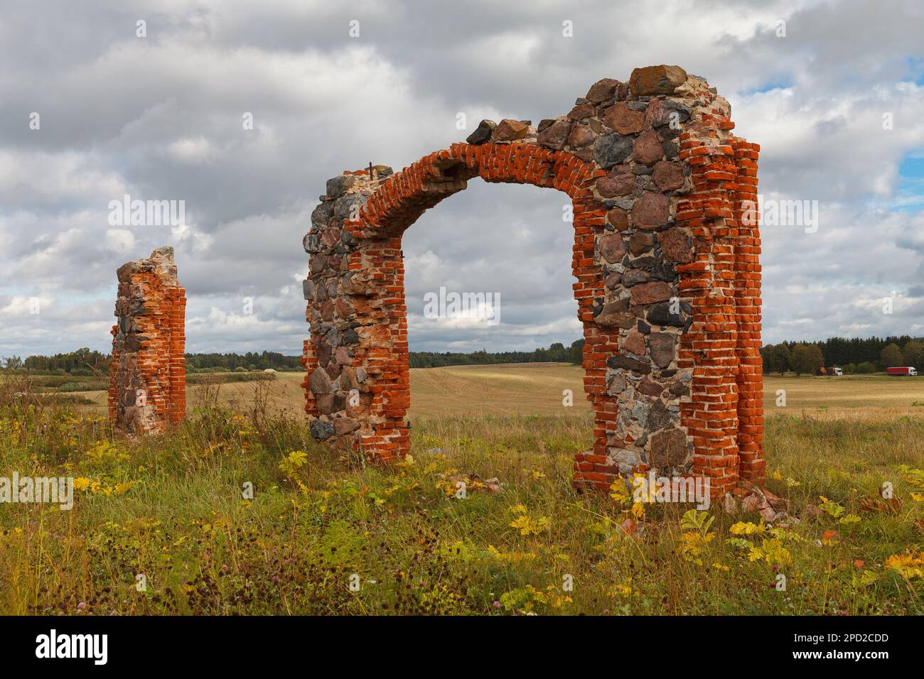 ruins of an old barn made of boulders and red bricks in the middle of a ...