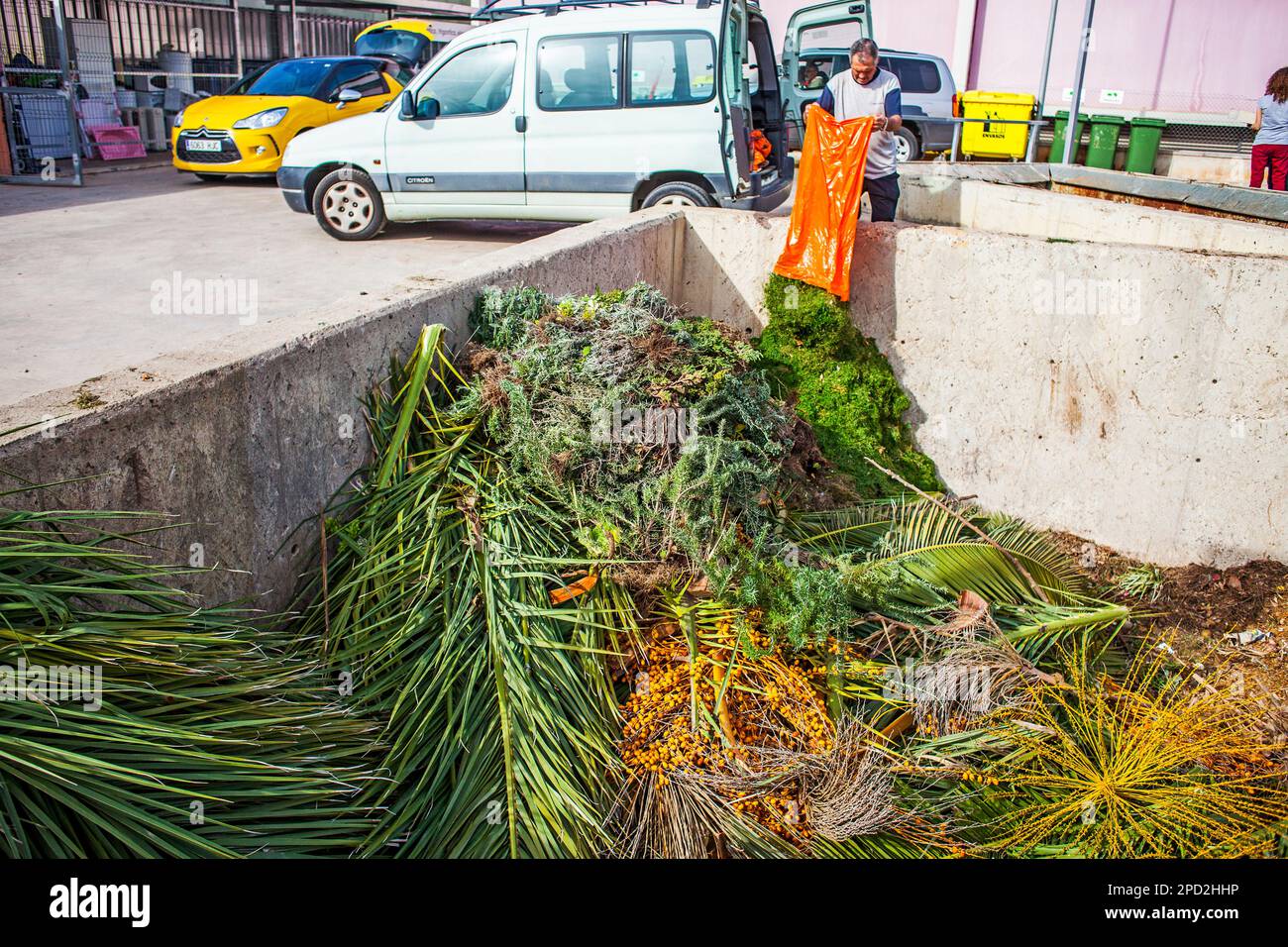 Man disposing of garden waste in a recycling centre Stock Photo Alamy