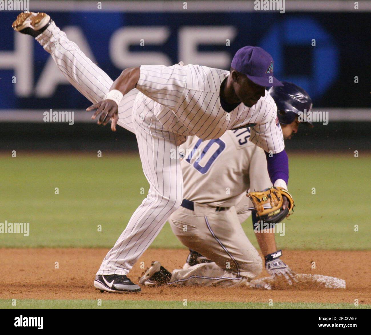 Arizona Diamondbacks second baseman Orlando Hudson, left, regains his  balance after San Diego Padres' Dave Roberts was unable to keep Hudson from  completing a double play during a baseball game Tuesday, May