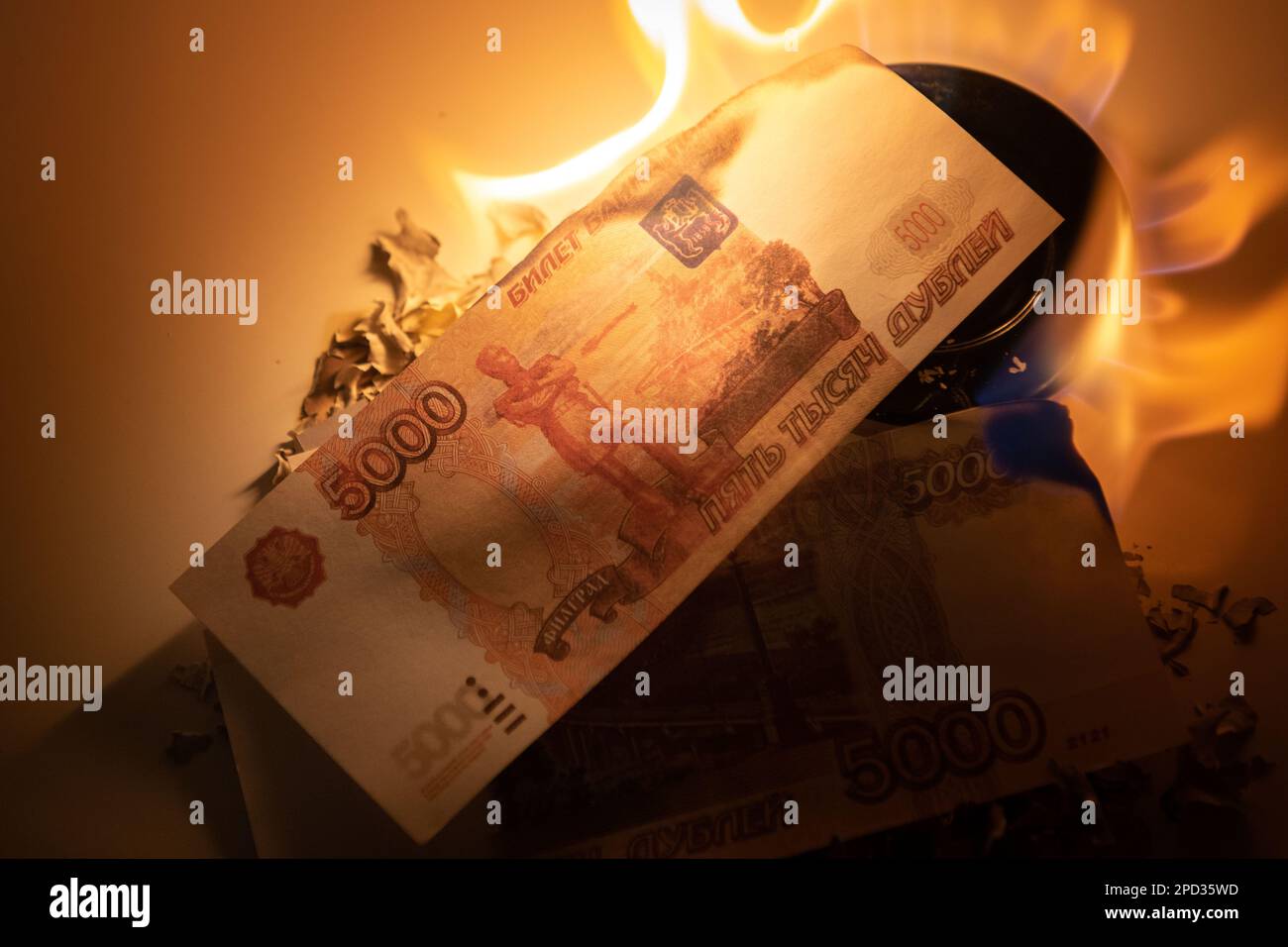 Burning rubles banknotes. High natural gas bills. Different denomination of bills. Close-up photo. Finance concept. Money background and texture. Stock Photo