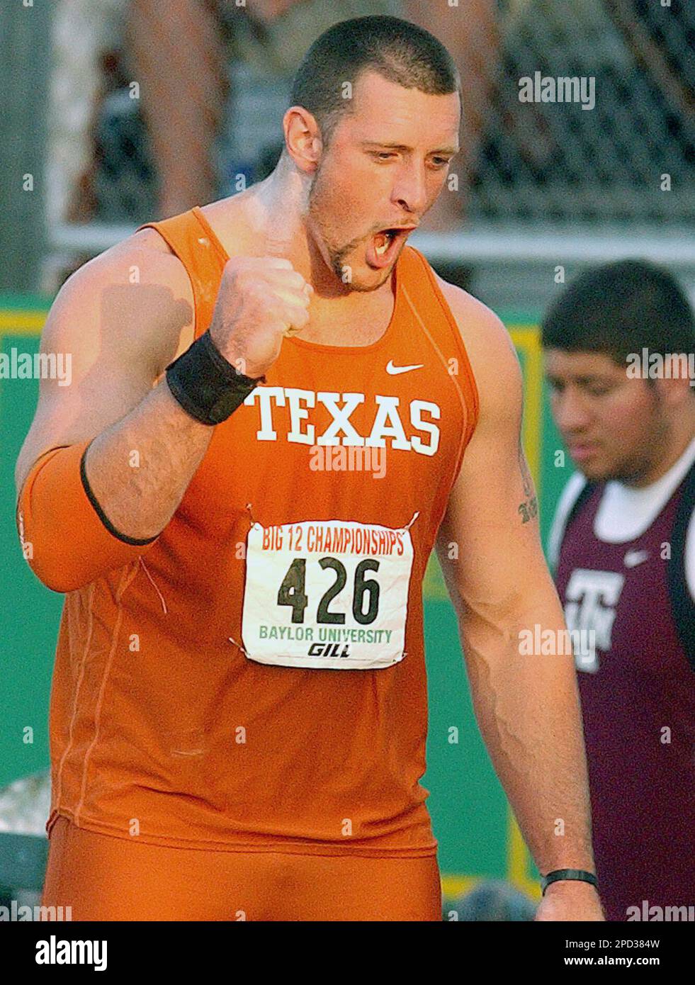 Texas' Brian Robison celebrates after winning the shot put eventy