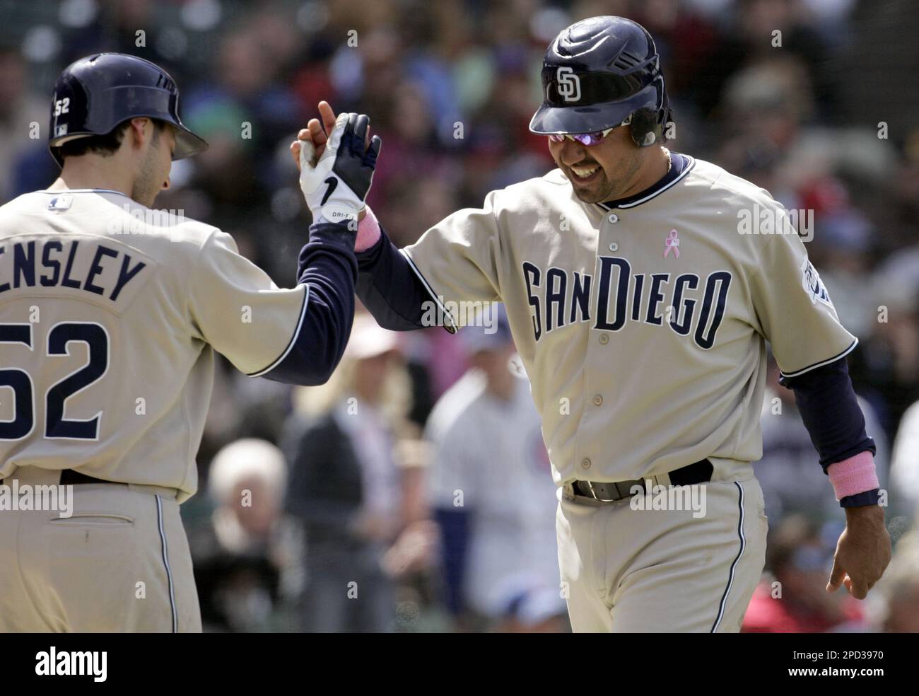 San Diego Padres' Vinny Castilla, right, smiles as he is congratulated by  teammate Clay Hensley after scoring on a wild pitch by Chicago Cubs pitcher  Scott Williamson during the sixth inning of