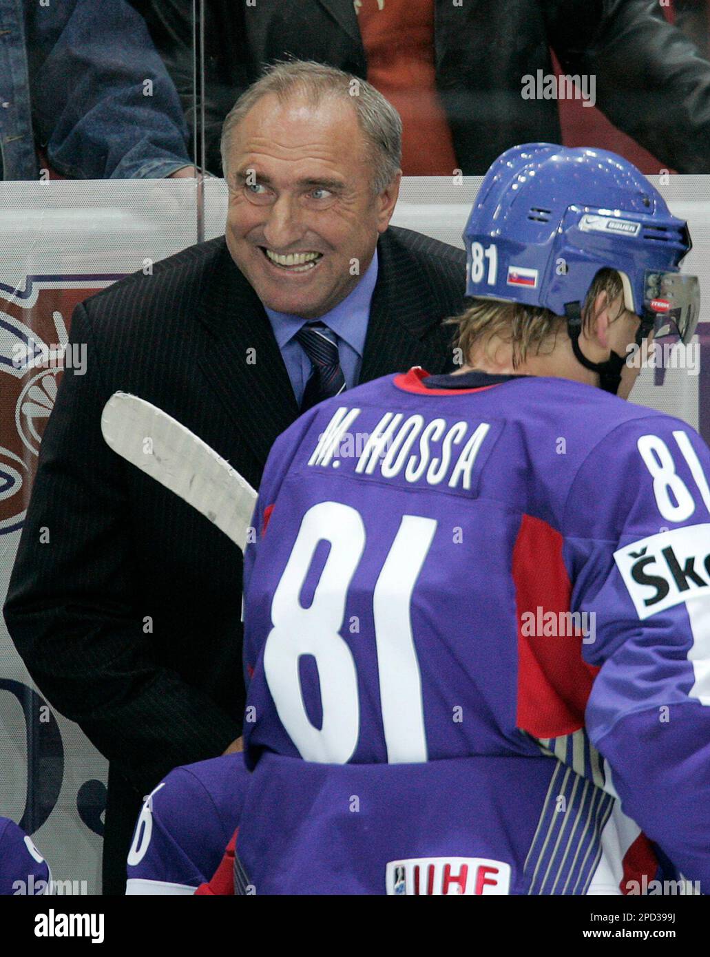 Slovakias coah Frantisek Hossa, left, smiles watching the end of his teams IIHF Ice Hockey World championship match against Sweden in Latvian capital Riga Sunday, May 14, 2006