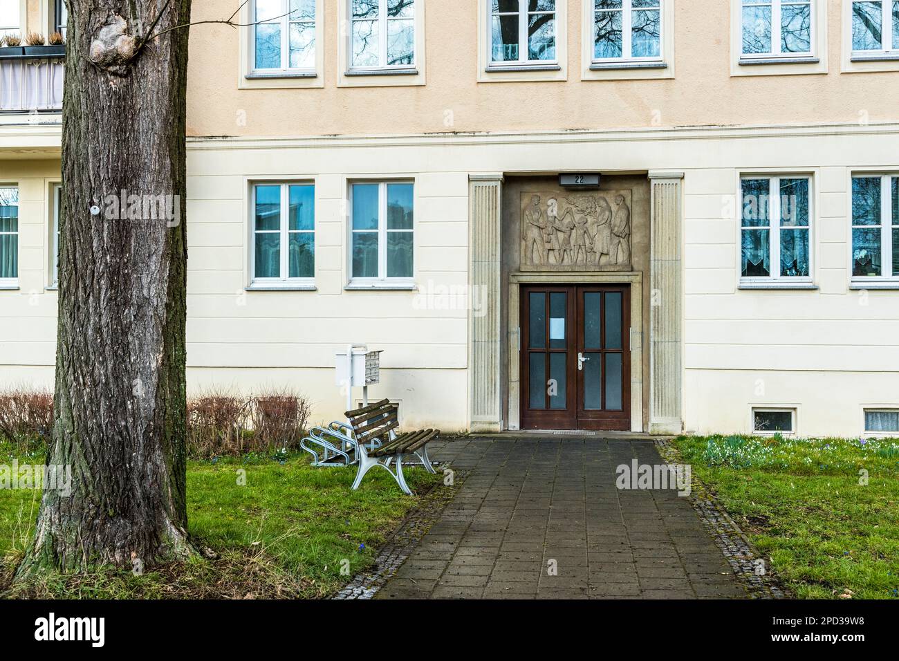 House entrance of a residential building area monument and planned city Eisenhüttenstadt, built from 1950 as an ideal city of the GDR. Here with facades designed in pictorial art, showing themes such as family, work and the common good. Architect Kurt W. Leucht Stock Photo