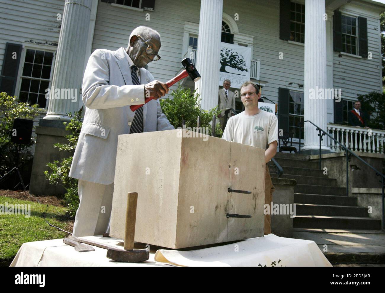 Philip Simmons hits the first plugs in the stone to split it during the