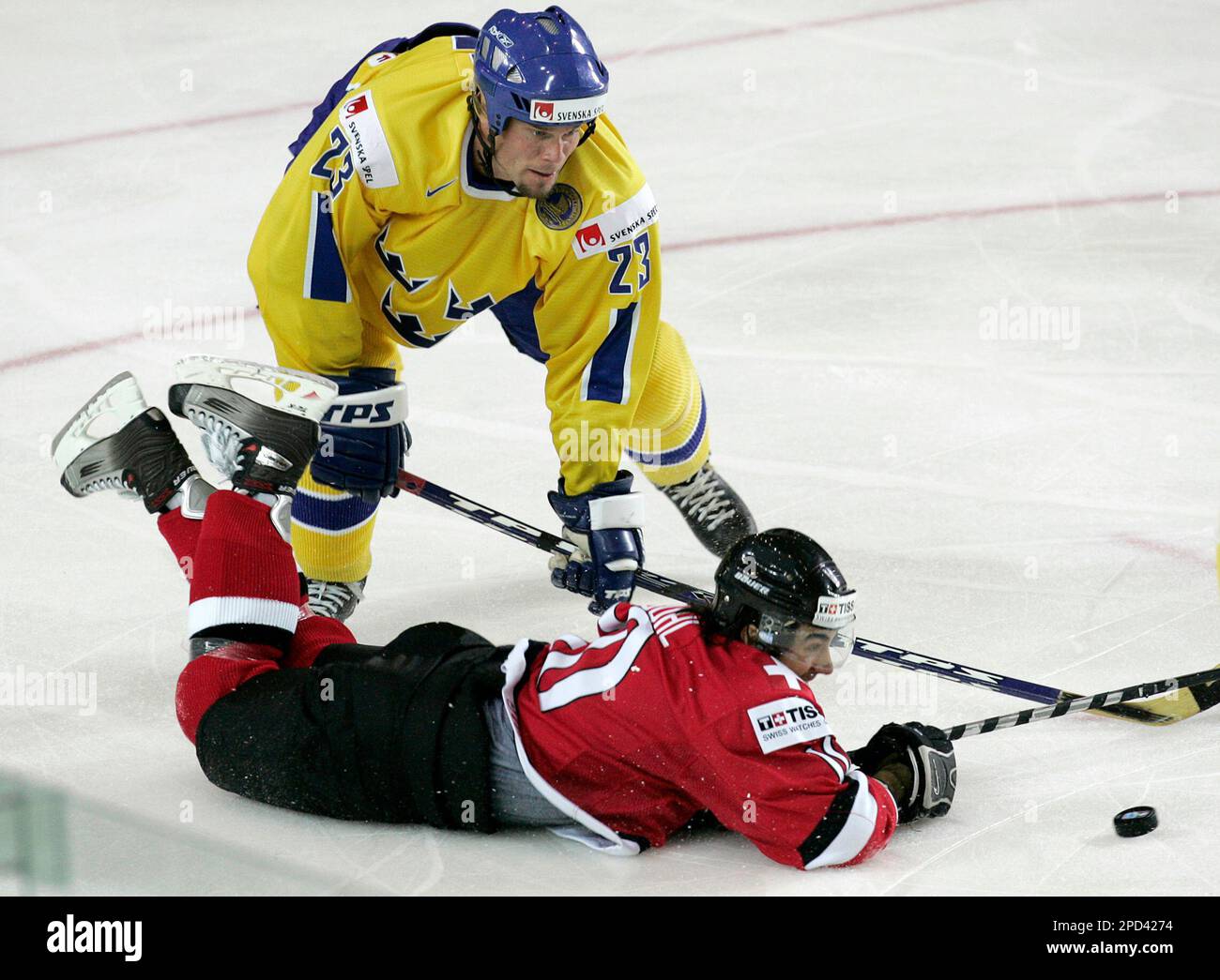 Swedens Ronnie Sundin, top, holds Switzerlands Andreas Ambuhl on the ice during their IIHF Ice Hockey World championship match in Latvian capital Riga Wednesday, May 10, 2006