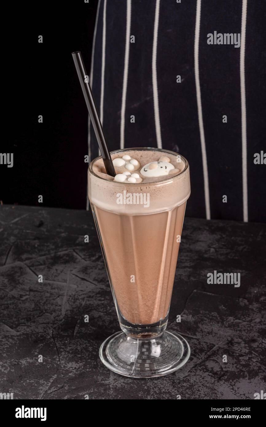 cocoa drink decorated with funny cookies on a dark background in a coffee shop Stock Photo