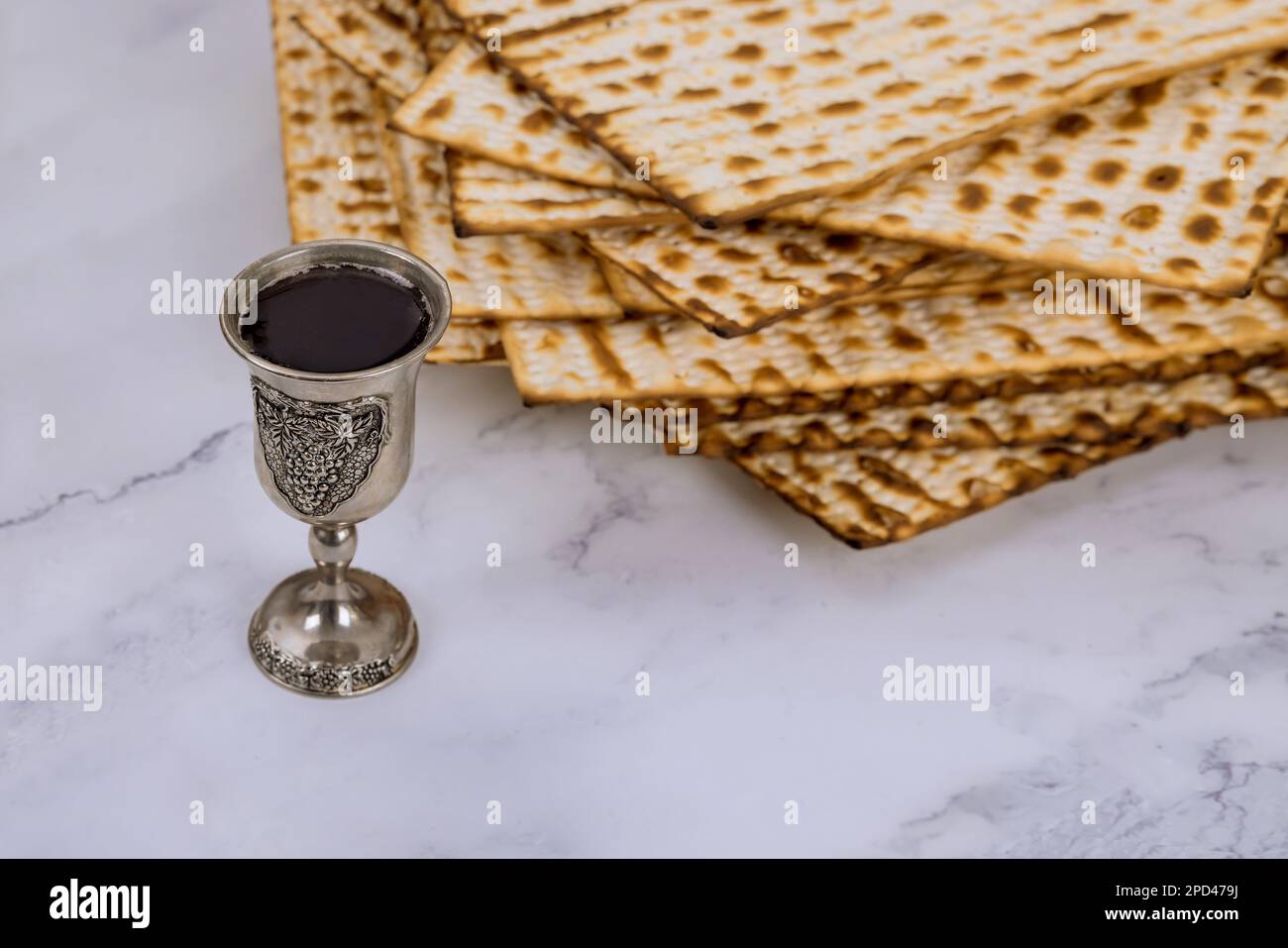 During Pesach, kosher kiddush cup wine is served with unleavened matzah bread Stock Photo